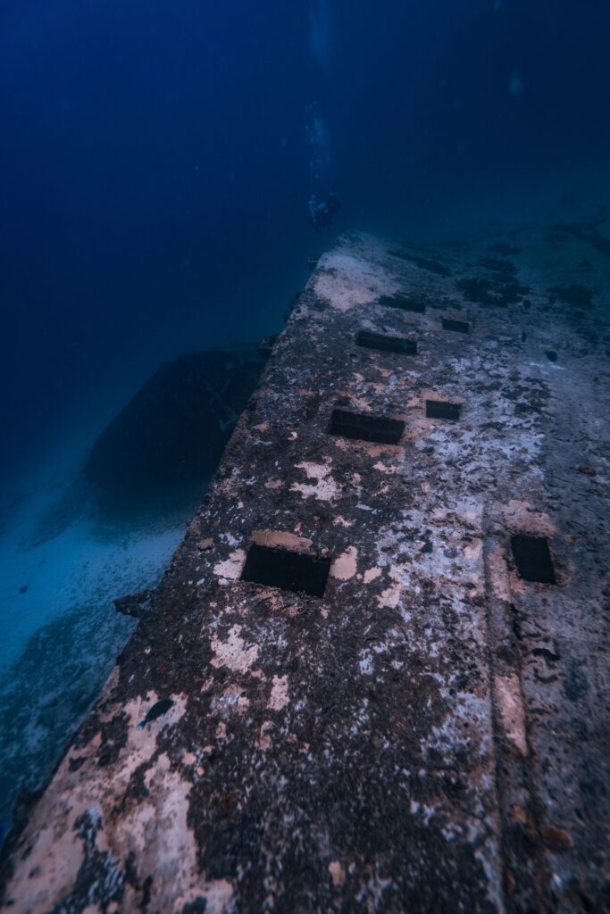 Explore a hauntingly beautiful underwater shipwreck resting on the ocean floor.