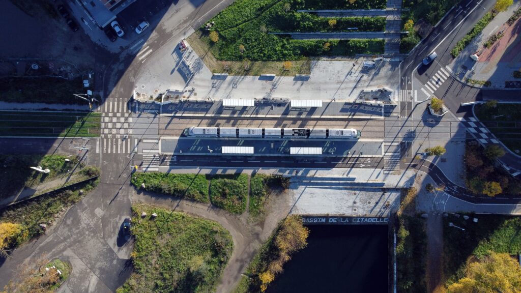 Aerial view of a tram and intersection in Strasbourg, France, showcasing transportation infrastructure.