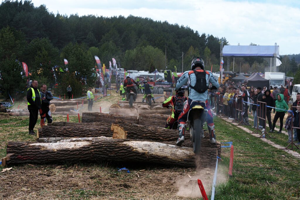 Dirt bike racers tackling obstacles at an outdoor event in Volkovysk, Belarus.