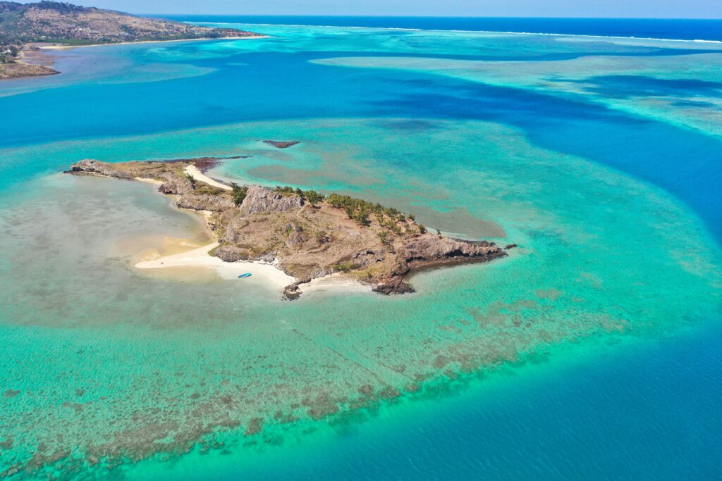 Stunning aerial shot of a serene island surrounded by turquoise waters in Mauritius.